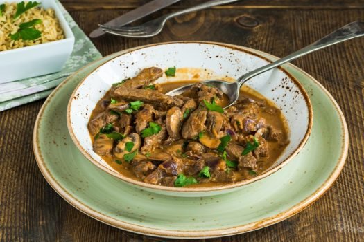 Beef,And,Mushroom,Stroganoff,With,Rice,On,Wooden,Table